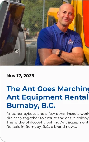 Blog post card dated Nov 17, 2023, titled "The Ant Goes Marching: Ant Equipment Rentals Burnaby, B.C.", with a photo of a staff member in an Ant Rentals polo shirt standing in front of equipment